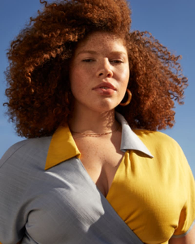 Front of a model wearing a size L Bowler Colorblocked Wrap Top in Sun & Sky by Lovefool. | dia_product_style_image_id:249736
